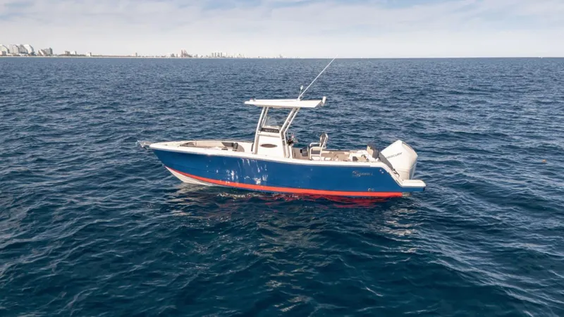 Slide: The Image of 2024 SeaWell 240CC boat on open ocean, clear sky, distant city skyline. - 36