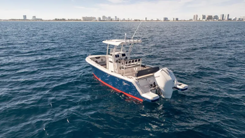 Slide: The Image of 2024 SeaWell 240CC boat on open water with city skyline in background. - 42
