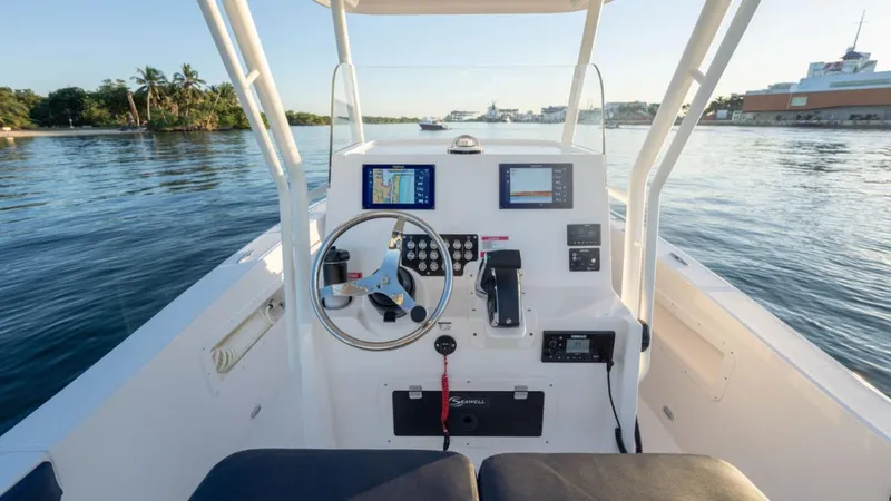 Slide: The Image of 2024 SeaWell 240CC boat cockpit with modern navigation equipment on calm waters. - 43