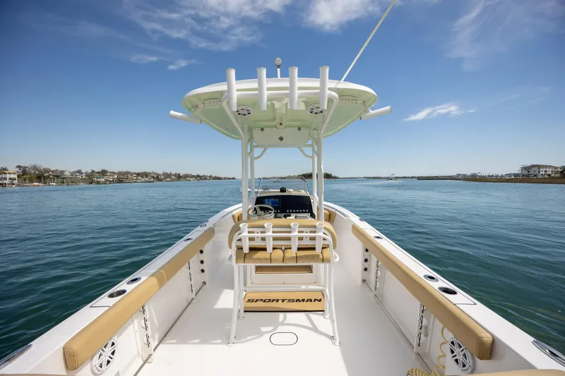 Slide: The Image of 2021 Sportsman Heritage 231 Center Console boat on calm water under blue sky. - 12