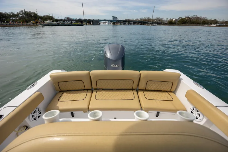 Slide: The Image of 2021 Sportsman Heritage 231 Center Console boat with tan seating on calm water. - 13