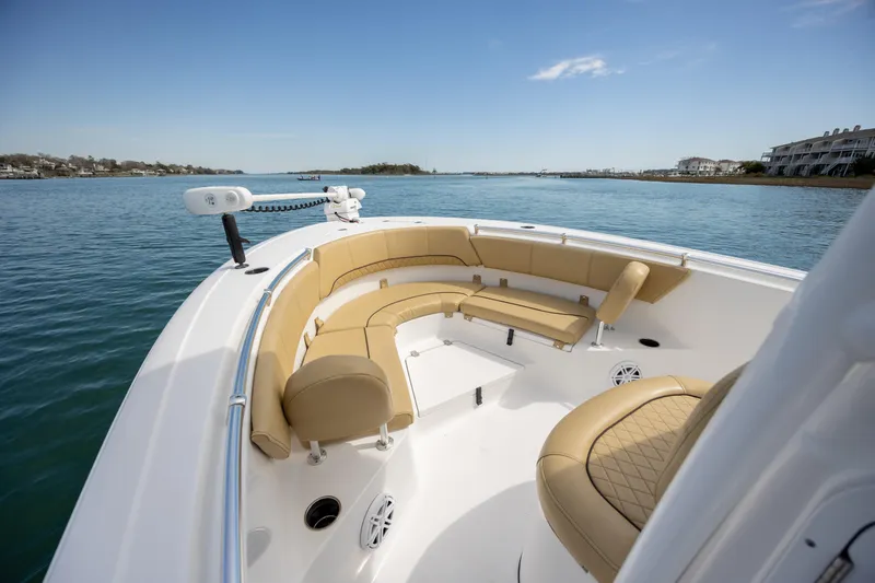Slide: The Image of 2021 Sportsman Heritage 231 Center Console boat with tan seating on calm water. - 15
