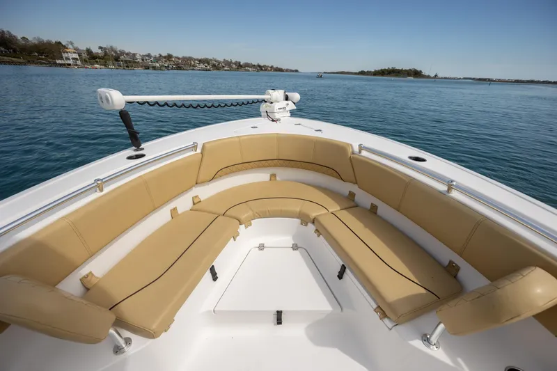 Slide: The Image of 2021 Sportsman Heritage 231 Center Console boat with tan seating on calm water. - 16
