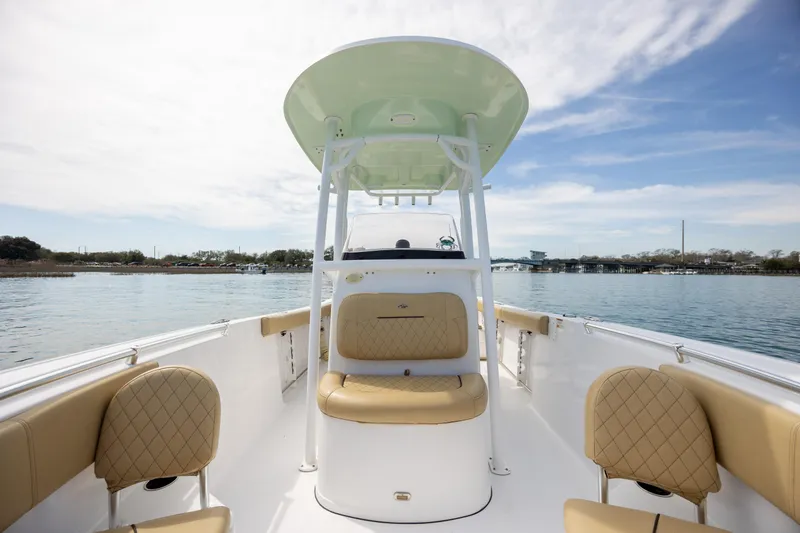 Slide: The Image of 2021 Sportsman Heritage 231 Center Console boat on calm water, featuring tan seating and T-top. - 17