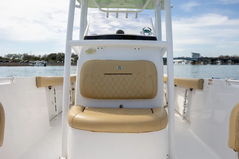 Slide: The Image of 2021 Sportsman Heritage 231 Center Console boat with tan seating, on a calm water backdrop. - 18