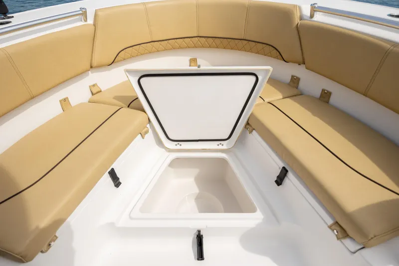 Slide: The Image of 2021 Sportsman Heritage 231 Center Console boat with tan seating and open storage compartment. - 20