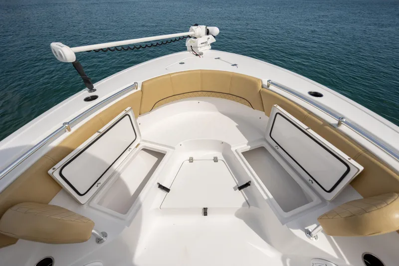Slide: The Image of 2021 Sportsman Heritage 231 Center Console boat with open storage compartments on calm water. - 21