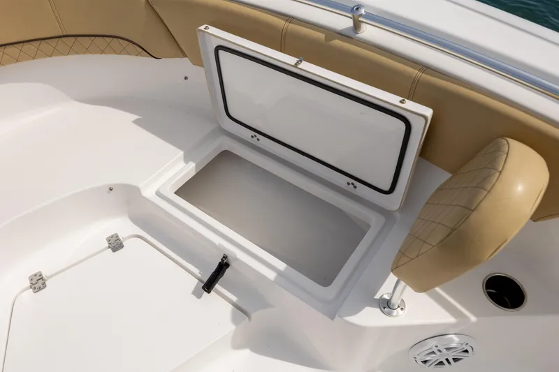 Slide: The Image of 2021 Sportsman Heritage 231 Center Console boat storage compartment open. - 22