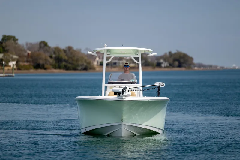 Slide: The Image of 2021 Sportsman Heritage 231 Center Console boat cruising on a calm waterway. - 4