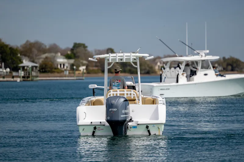 Slide: The Image of 2021 Sportsman Heritage 231 Center Console boat cruising on a calm waterway. - 7