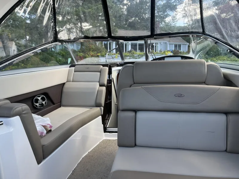 Slide: The Image of 2014 Regal 28 Express boat interior with gray seating and clear canopy. - 4