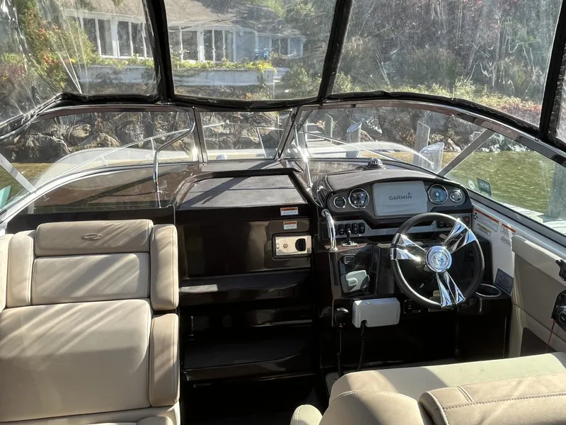 Slide: The Image of Interior view of 2014 Regal 28 Express boat cockpit with steering wheel and seating. - 7