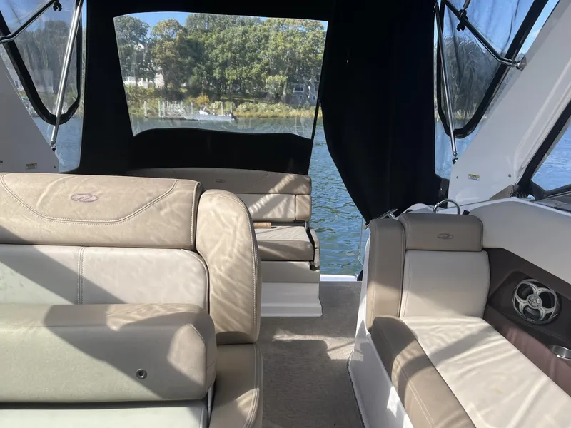 Slide: The Image of Interior of 2014 Regal 28 Express boat with beige seating and water view. - 9