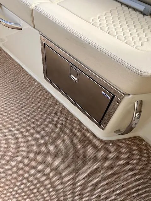 Slide: The Image of 2022 Chris-Craft Launch 28 GT interior with beige seating and storage compartment. - 14