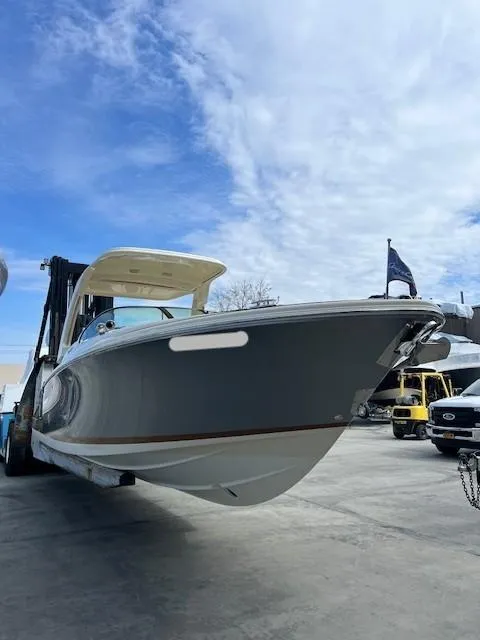 Slide: The Image of 2022 Chris-Craft Launch 28 GT boat on trailer under blue sky. - 3