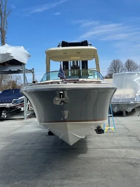 Slide: The Image of 2022 Chris-Craft Launch 28 GT boat on display, front view under clear blue sky. - 4