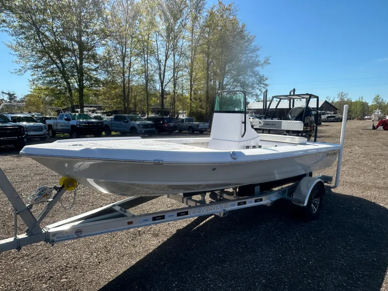 Slide: The Image of 2025 Action Craft 17 Flats Flyfisher boat on trailer in outdoor setting. - 11