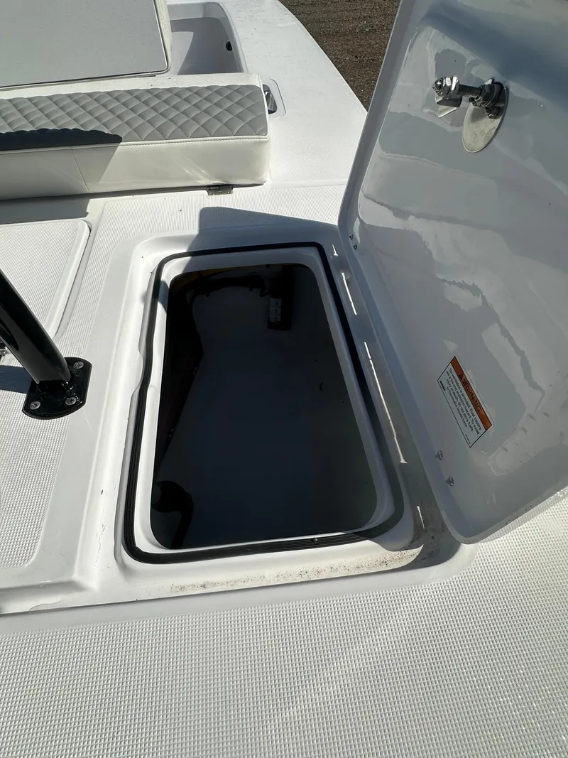 Slide: The Image of 2025 Action Craft 17 Flats Flyfisher boat storage compartment with open hatch. - 12