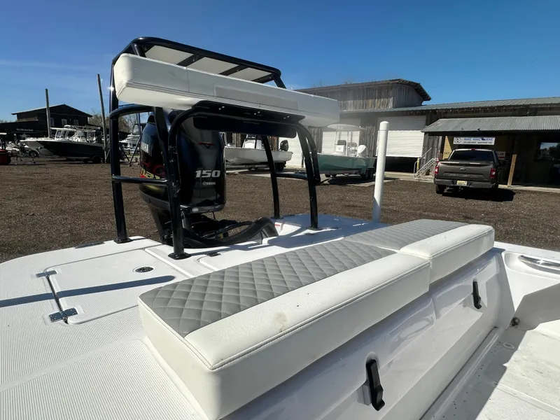 Slide: The Image of 2025 Action Craft 17 Flats Flyfisher boat with cushioned seating and powerful outboard motor. - 14