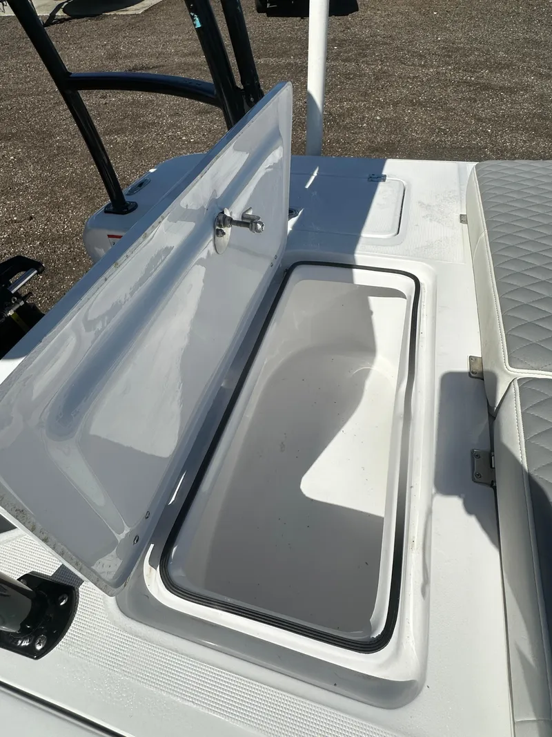 Slide: The Image of 2025 Action Craft 17 Flats Flyfisher boat storage compartment open on deck. - 15