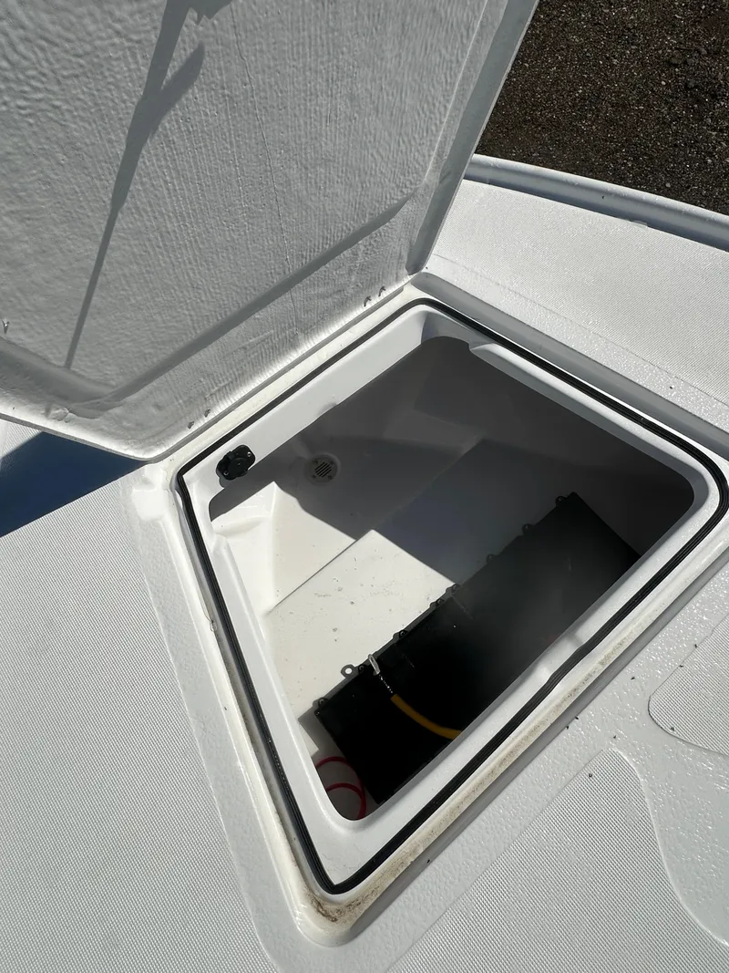 Slide: The Image of 2025 Action Craft 17 Flats Flyfisher storage compartment open, showcasing interior space. - 19