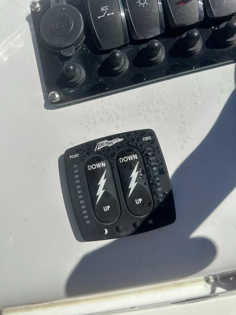 Slide: The Image of Control panel of 2025 Action Craft 17 Flats Flyfisher boat with trim tab switches. - 24