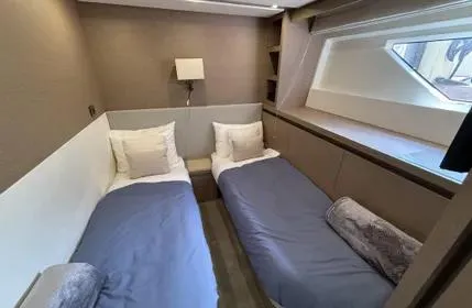 Slide: The Image of Twin cabin in 2018 Prestige 680 yacht with modern decor and large window. - 16