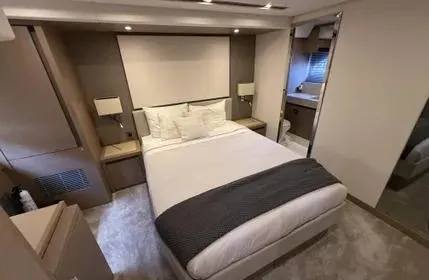 Slide: The Image of Luxurious bedroom interior of 2018 Prestige 680 yacht with modern design and cozy ambiance. - 7