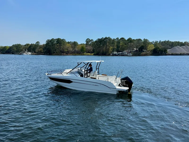 Slide: The Image of 2024 Beneteau Flyer 8 SUNdeck boat cruising on a serene lake. - 10