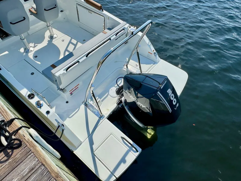 Slide: The Image of 2024 Beneteau Flyer 8 SUNdeck boat with outboard motor, docked on water. - 14