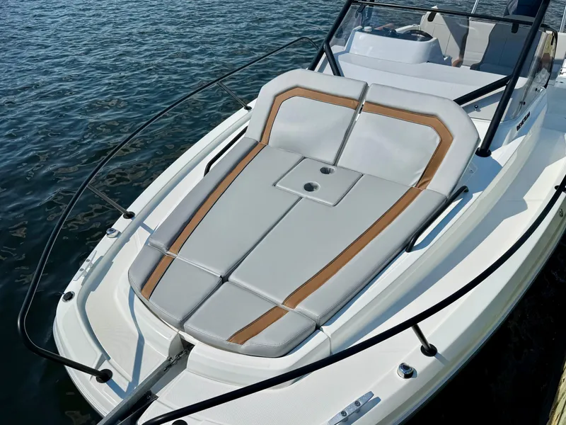Slide: The Image of 2024 Beneteau Flyer 8 SUNdeck boat with sleek sunbathing area on calm water. - 16
