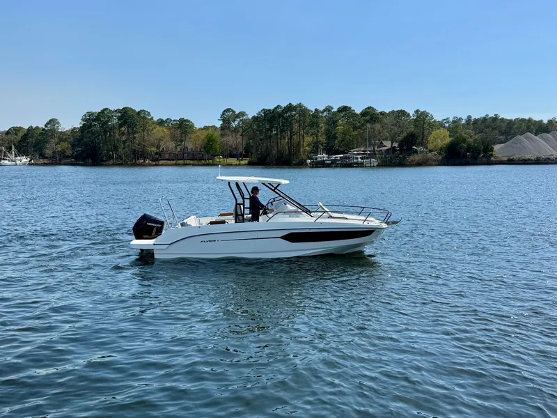 Slide: The Image of 2024 Beneteau Flyer 8 SUNdeck boat cruising on a serene lake. - 6