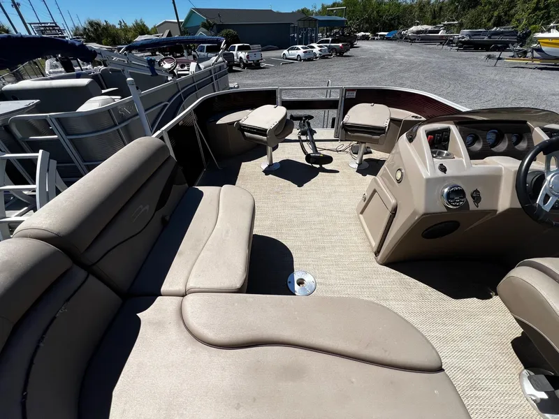 Slide: The Image of 2019 Bennington SX20 SFX pontoon boat interior with beige seating and helm. - 10