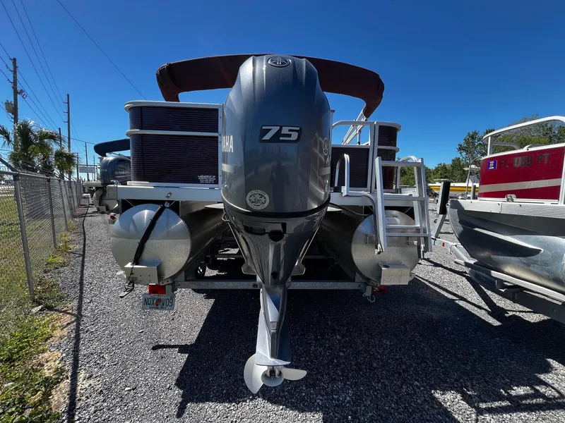 Slide: The Image of 2019 Bennington SX20 SFX pontoon boat with Yamaha 75 engine, parked on gravel. - 4