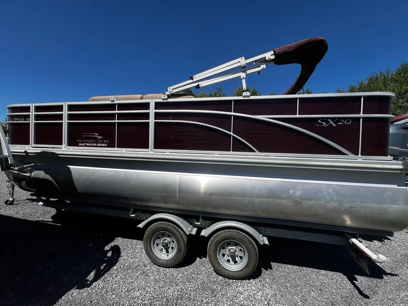 Slide: The Image of 2019 Bennington SX20 SFX pontoon boat on a trailer, parked outdoors. - 5