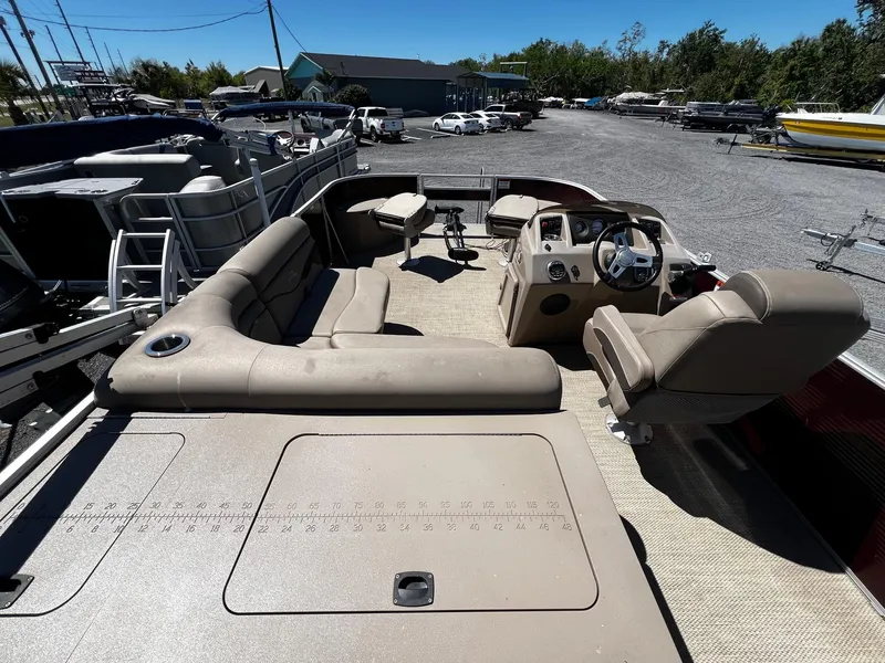 Slide: The Image of 2019 Bennington SX20 SFX pontoon boat with beige seating, steering console, and spacious deck. - 6
