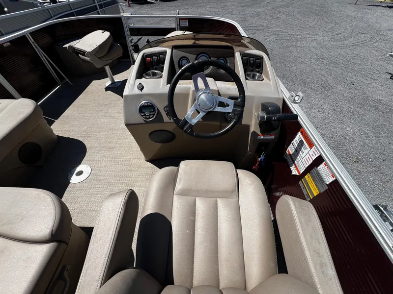 Slide: The Image of 2019 Bennington SX20 SFX boat interior with steering wheel and beige seating. - 8