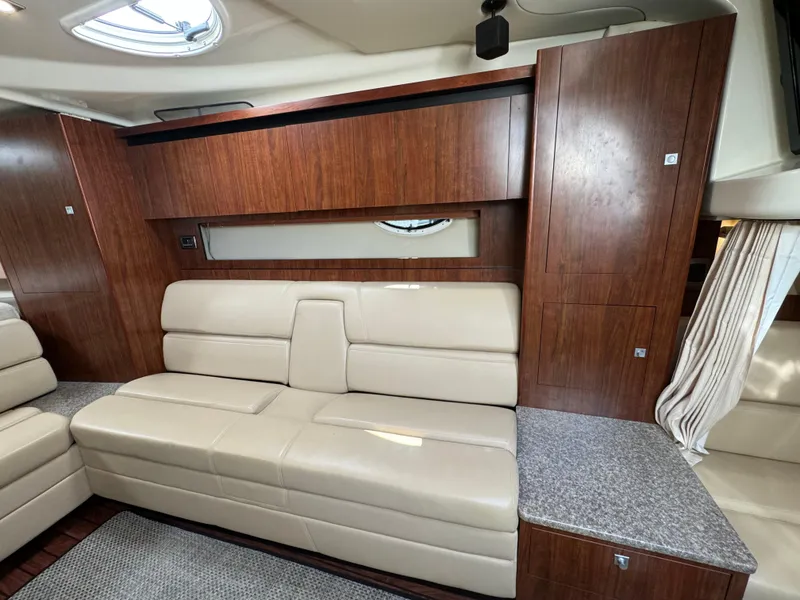 Slide: The Image of 2014 Monterey 340 Sport Yacht interior with beige leather seating and wood paneling. - 16