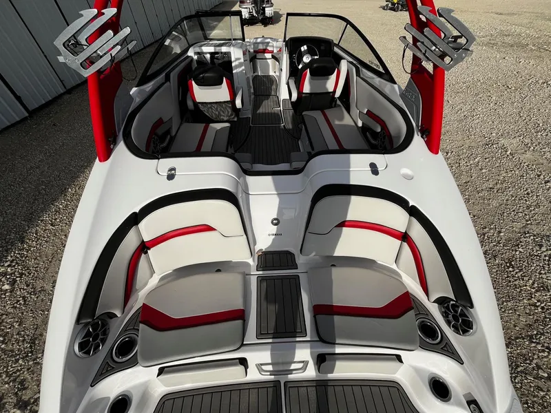 Slide: The Image of 2018 Yamaha Boats 242X E-Series interior with red and gray seating, sleek design. - 11