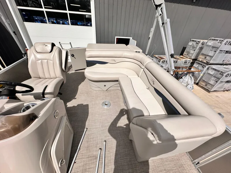 Slide: The Image of 2019 Bennington 20 SLM Pontoon interior with beige seating and steering console. - 10