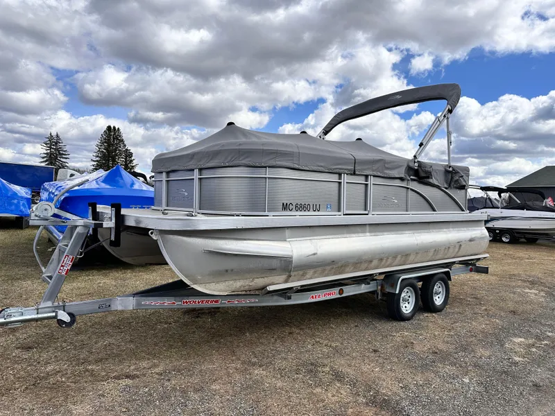 Slide: The Image of 2019 Bennington 20 SLM Pontoon boat on trailer under cloudy sky. - 4