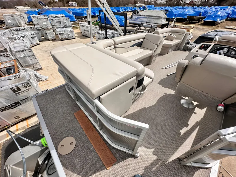 Slide: The Image of 2019 Bennington 20 SLM Pontoon boat interior with beige seating and helm. - 6