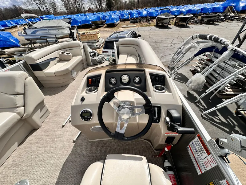 Slide: The Image of 2019 Bennington 20 SLM Pontoon boat interior with steering wheel and seating area. - 8