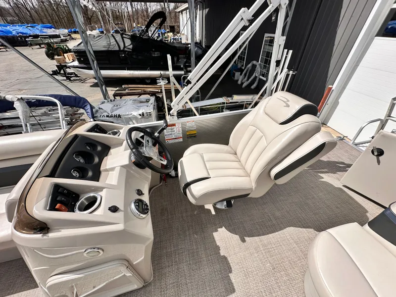 Slide: The Image of 2019 Bennington 20 SLM Pontoon boat interior with steering console and captain's chair. - 9