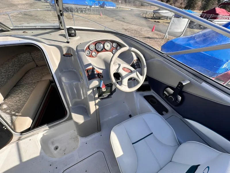 Slide: The Image of 1997 Bayliner 2352LS Cuddy boat interior with steering wheel and cabin seating. - 5