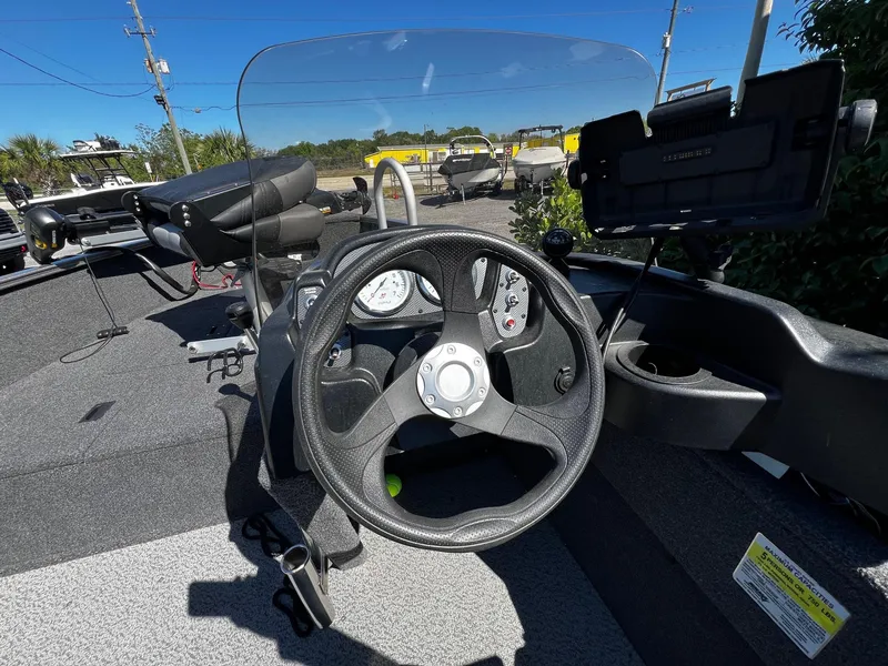 Slide: The Image of 2023 Crestliner 1600 Vision boat dashboard with steering wheel and gauges. - 10