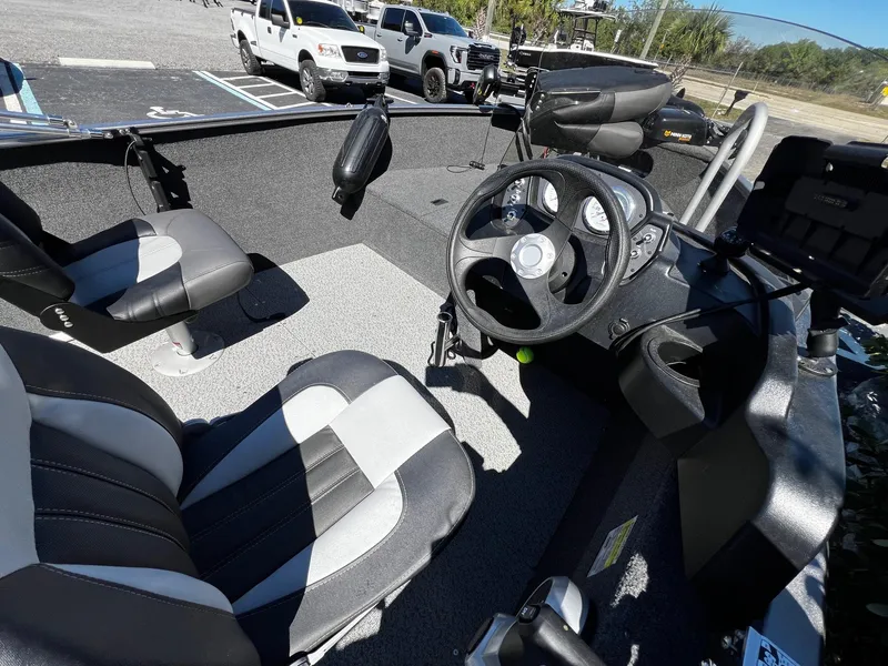 Slide: The Image of 2023 Crestliner 1600 Vision boat interior with steering wheel and seating. - 11