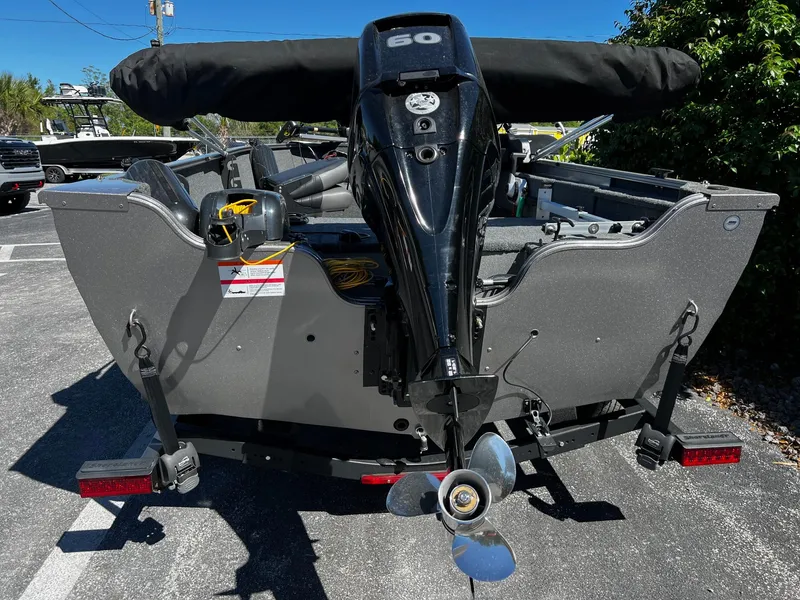 Slide: The Image of 2023 Crestliner 1600 Vision boat with outboard motor, parked outdoors. - 5