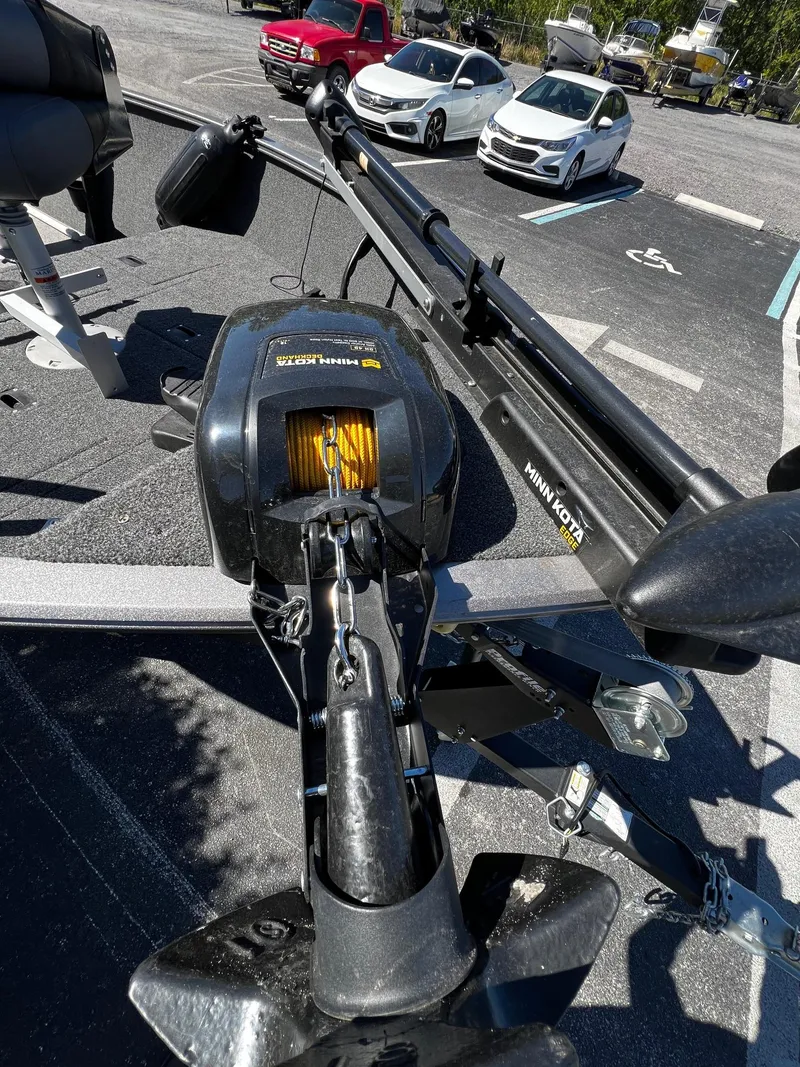 Slide: The Image of 2023 Crestliner 1600 Vision boat with Minn Kota trolling motor in parking lot. - 6