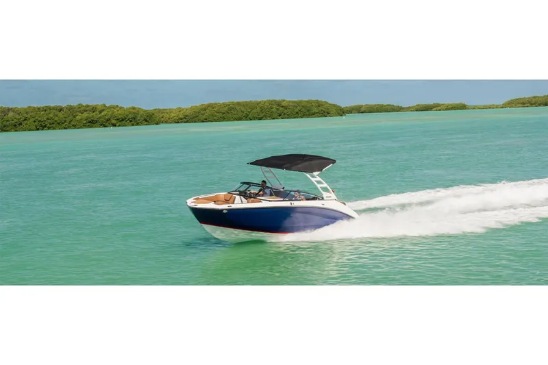 Slide: The Image of 2025 Yamaha Boats 252SE cruising on turquoise water with lush green backdrop. - 10